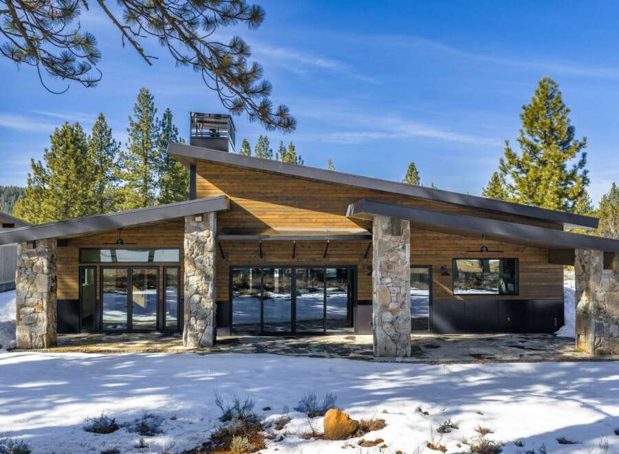 This stunning modern home boasts a striking architectural design with a blend of natural materials.