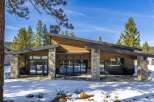 This stunning modern home boasts a striking architectural design with a blend of natural materials.