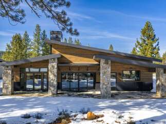 This stunning modern home boasts a striking architectural design with a blend of natural materials.