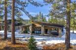 Nestled in a serene, snow-covered landscape, this stunning property boasts a modern architectural design with a blend of natural elements.