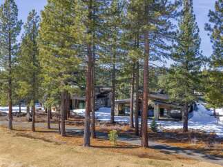 Nestled amidst towering trees, this stunning property offers a serene escape.