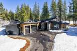 This stunning modern home boasts a sleek design with a blend of wood and stone accents.