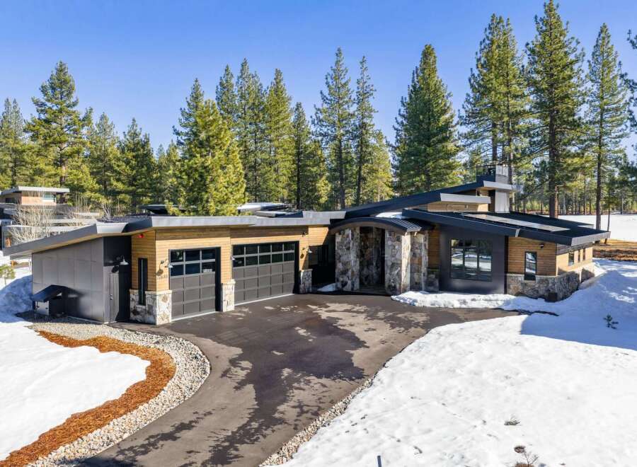 This stunning modern home boasts a sleek design with a blend of natural elements.