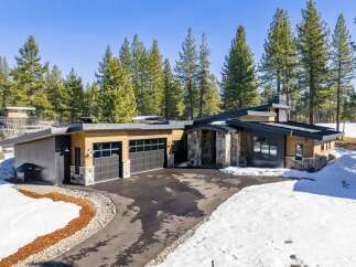 This stunning modern home boasts a sleek design with a blend of natural elements.