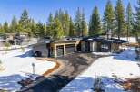 This stunning modern home boasts a sleek design with a blend of natural wood and stone accents.