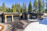 This stunning modern home boasts a sleek design with a combination of wood and stone elements.