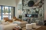 Experience luxury living in this stunning property featuring a grand stone fireplace, perfect for cozy evenings.