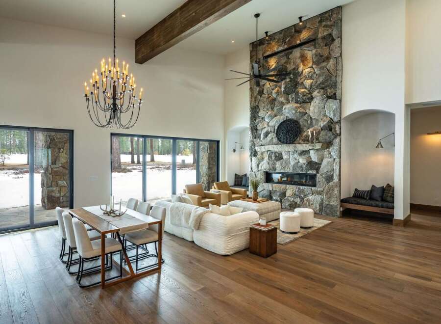 Experience luxury living in this stunning property featuring a grand stone fireplace, perfect for cozy evenings.