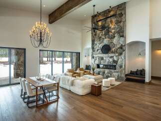 Experience luxury living in this stunning property featuring a grand stone fireplace, perfect for cozy evenings.