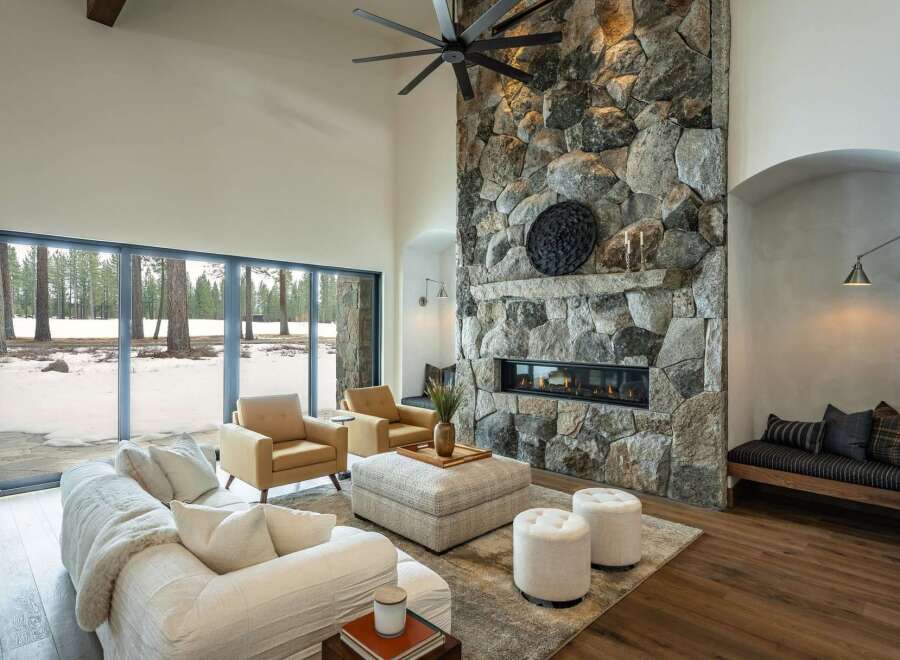 This stunning living room boasts a striking stone fireplace, creating a cozy and inviting atmosphere.