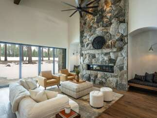 This stunning living room boasts a striking stone fireplace, creating a cozy and inviting atmosphere.