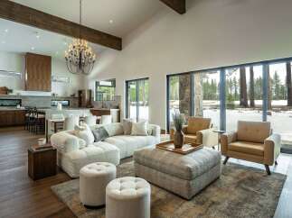 Experience luxury living in this stunning property, featuring a spacious living room with a modern design and high ceilings.