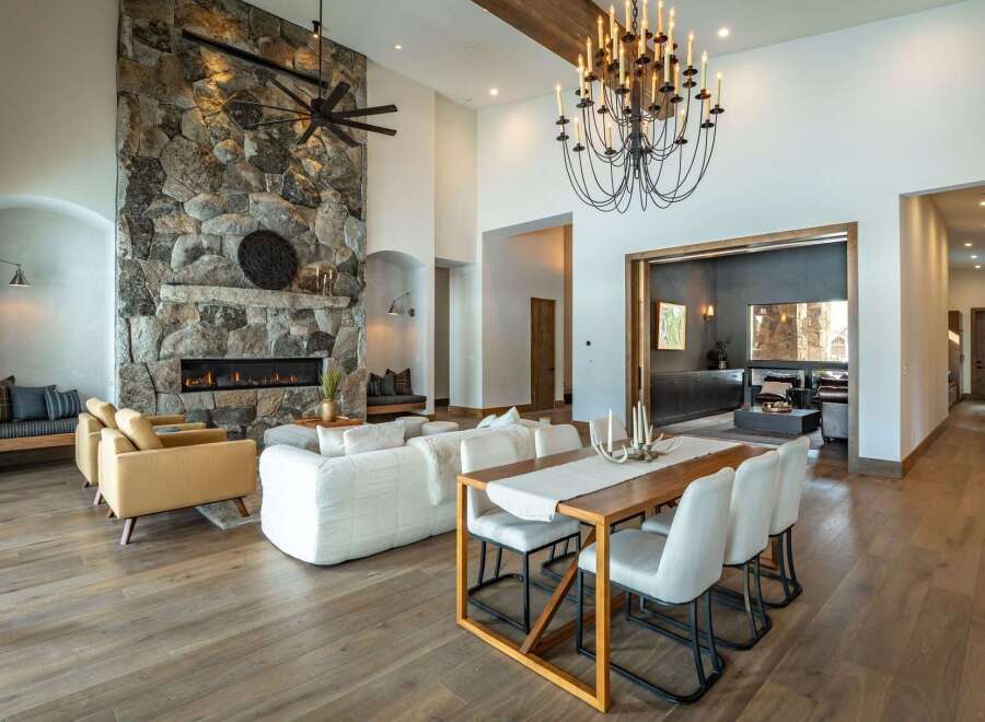 This stunning property boasts a grand stone fireplace, creating a cozy focal point in the living area.