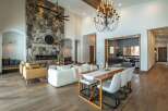 This stunning property boasts a grand stone fireplace, creating a cozy focal point in the living area.