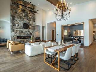 This stunning property boasts a grand stone fireplace, creating a cozy focal point in the living area.