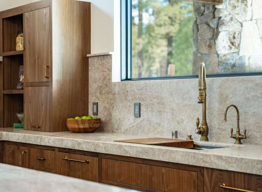 Experience luxury living in this stunning kitchen! Featuring custom wood cabinetry, a sleek countertop, and high-end fixtures, this space is perfect for both cooking and entertaining.