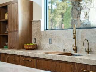 Experience luxury living in this stunning kitchen! Featuring custom wood cabinetry, a sleek countertop, and high-end fixtures, this space is perfect for both cooking and entertaining.
