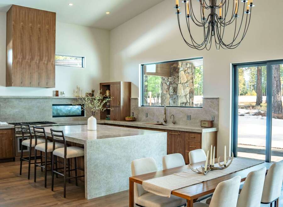 This stunning kitchen and dining area boasts a modern design with high-end finishes.