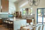 This stunning kitchen and dining area boasts a modern design with high-end finishes.