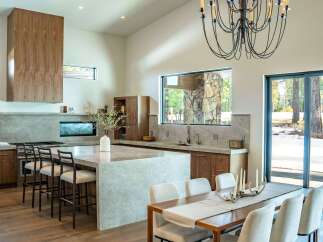 This stunning kitchen and dining area boasts a modern design with high-end finishes.