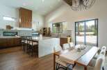Experience luxury living in this stunning modern kitchen and dining area.
