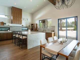 Experience luxury living in this stunning modern kitchen and dining area.