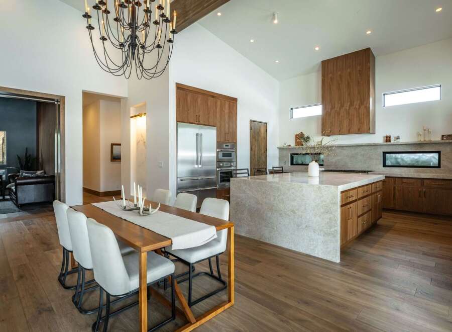 This stunning kitchen and dining area boasts a modern design with high-end finishes.