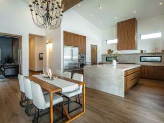 This stunning kitchen and dining area boasts a modern design with high-end finishes.