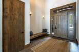 Step into luxury with this stunning entryway! Featuring a beautiful wooden door and a cozy bench, this space is perfect for welcoming guests.