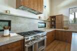This stunning kitchen boasts high-end appliances and custom cabinetry, perfect for the discerning homeowner.