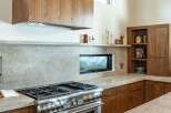 This stunning kitchen boasts a modern design with high-end appliances and custom cabinetry.