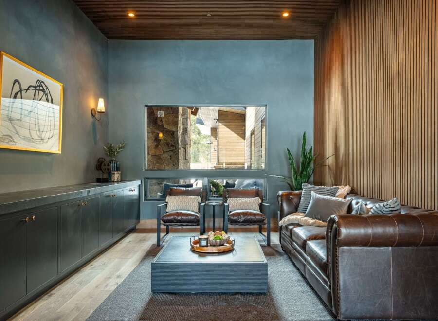 Step into luxury with this stunning living room, featuring a cozy leather sofa and stylish accent chairs.