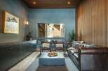 Step into luxury with this stunning living room, featuring a cozy leather sofa and stylish accent chairs.