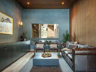 Step into luxury with this stunning living room, featuring a cozy leather sofa and stylish accent chairs.