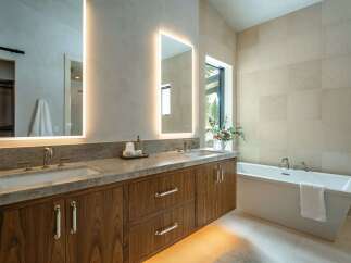 Step into luxury with this stunning bathroom featuring a sleek, modern design.