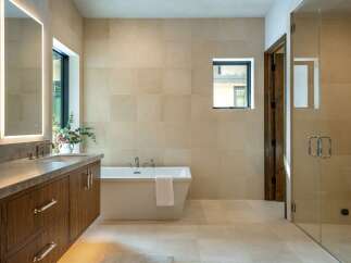 Step into luxury with this stunning bathroom featuring a modern design and high-end finishes.
