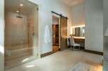 Step into luxury with this stunning bathroom, featuring a spacious glass-enclosed shower and elegant vanity area.