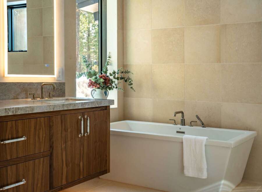 Step into luxury with this stunning bathroom featuring a sleek, modern design.