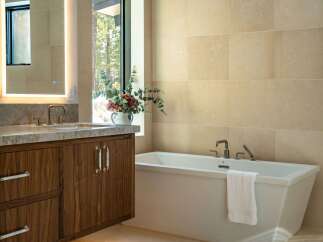 Step into luxury with this stunning bathroom featuring a sleek, modern design.