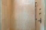 Step into luxury with this stunning shower featuring elegant tile work and a built-in bench.