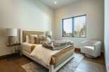 Step into this serene bedroom, showcasing a blend of modern design and natural elements.