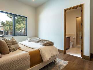 Step into this inviting bedroom, featuring a cozy bed and a serene atmosphere.