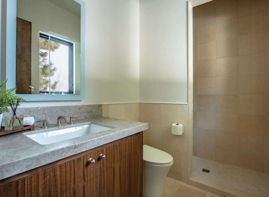 This stunning bathroom boasts a modern design with a sleek vanity and a spacious walk-in shower.