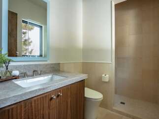 This stunning bathroom boasts a modern design with a sleek vanity and a spacious walk-in shower.