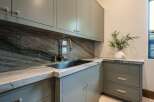 This stunning kitchen boasts a luxurious design with elegant cabinetry and a sleek marble countertop.