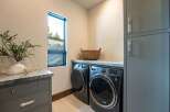 Discover the epitome of modern living in this stunning property, featuring a beautifully designed laundry room.