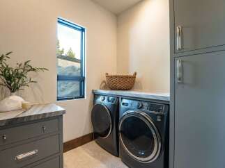 Discover the epitome of modern living in this stunning property, featuring a beautifully designed laundry room.