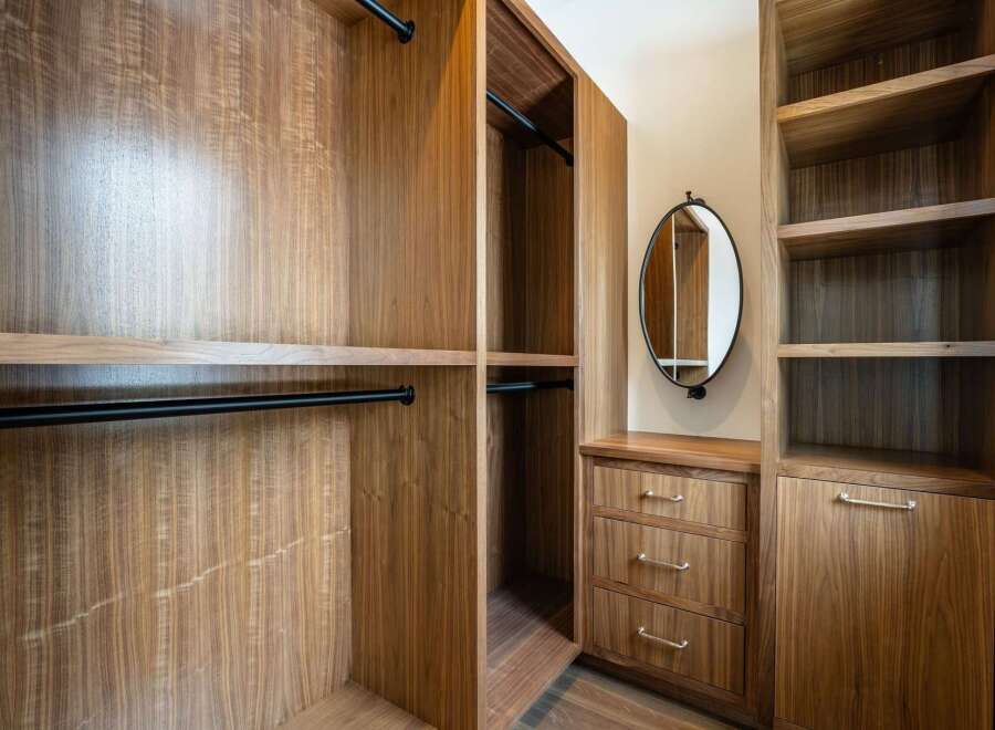 Step into luxury with this custom-built walk-in closet, designed for both style and functionality.