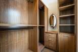 Step into luxury with this custom-built walk-in closet, designed for both style and functionality.