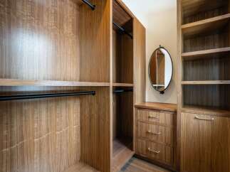 Step into luxury with this custom-built walk-in closet, designed for both style and functionality.